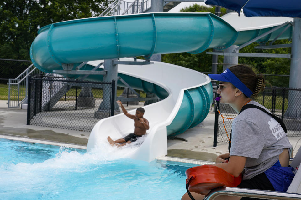 Lifeguard Rachel Mees, 21, watches over the swimmers at the Douglass Park pool in Indianapolis, Friday, June 17, 2022. Indianapolis typically fills 17 pools each year, but with a national lifeguard shortage exacerbated by the COVID-19 pandemic, just five are open this summer. The American Lifeguard Association estimates one-third of pools in the United States are impacted by the shortage. (AP Photo/Michael Conroy)