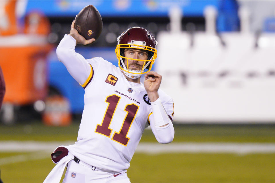 FILE - Washington Football Team quarterback Alex Smith warms up before an NFL football game against the Philadelphia Eagles in Philadelphia, in this Sunday, Jan. 3, 2021, file photo. Washington’s biggest offseason need is to figure out its quarterback situation. Trade for DeShaun Watson? Sign Cam Newton? Roll with Alex Smith and Kyle Allen? Coach Ron Rivera says “nothing is off the table.” (AP Photo/Chris Szagola, File)