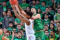 Jan 26, 2019; South Bend, IN, USA; Virginia Cavaliers guard De'Andre Hunter (12) and Notre Dame Fighting Irish forward John Mooney (33) reach for a rebound in the second half at the Purcell Pavilion. Mandatory Credit: Matt Cashore-USA TODAY Sports