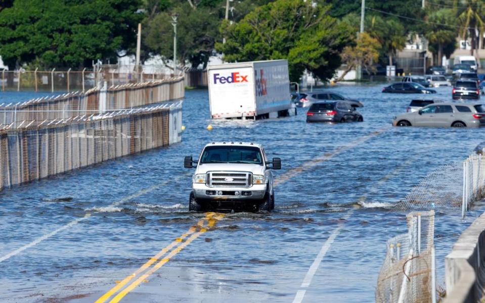 A truck drives through the flooded West Perimeter Road in the Fort Lauderdale on Thursday, April 13, 2023. David Santiago/dsantiago@miamiherald.com