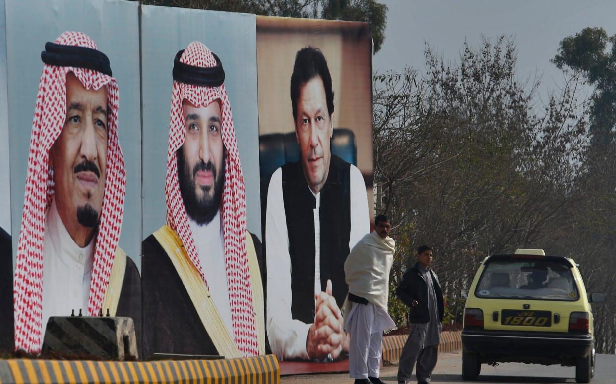 Portraits of King Salman of Saudi Arabia, crown prince Mohammed bin Salman, and Pakistani prime minister Imran Khan are displayed on a highway in Islamabad - AP