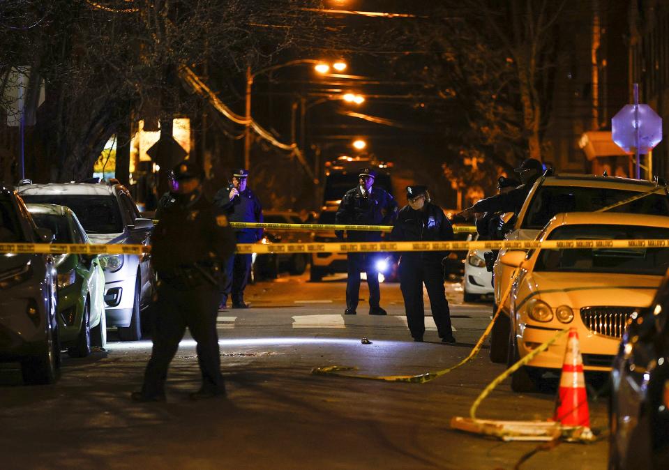 Philadelphia police officers investigate the fatal shooting of a Temple University police officer near the campus on Saturday, Feb. 18, 2023, in Philadelphia.