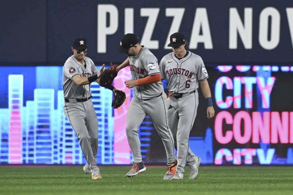 Houston Astros' Mauricio Dubon, from left, Chas McCormick (20) and Jake Meyers (6) celebrate their team's victory over the Toronto Blue Jays in a baseball game in Toronto on Wednesday, July 3, 2024. (Jon Blacker/The Canadian Press via AP)