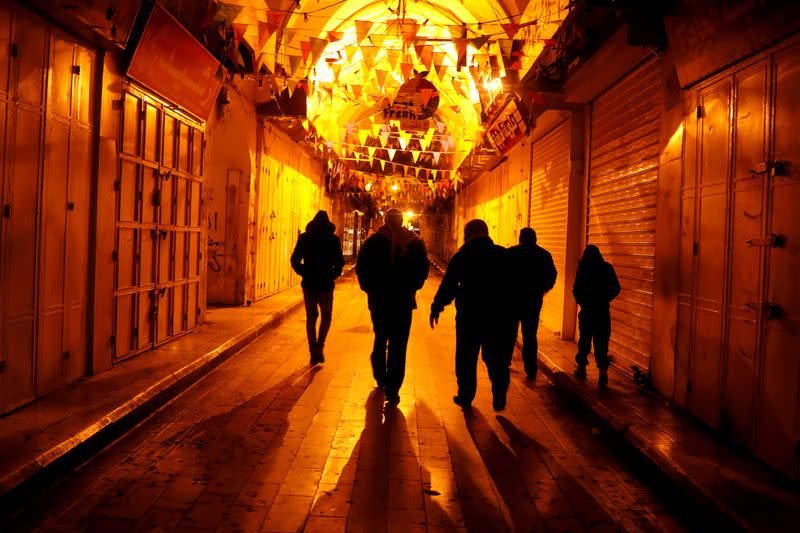 Palestinians make their way to attend the Fajr dawn prayer at Al-Nasir mosque in Nablus in the Israeli-occupied West Bank