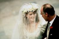 <p>When Sarah Ferguson headed down the aisle on the arm of her father in 1986, <a href="https://www.goodhousekeeping.com/beauty/fashion/a22574019/sarah-ferguson-wedding-crown/" rel="nofollow noopener" target="_blank" data-ylk="slk:she wore a gorgeous flower headdress;elm:context_link;itc:0" class="link ">she wore a gorgeous flower headdress</a>. After she signed her marriage certificate, she removed it and revealed the stunning brand-new York tiara, especially commissioned for the wedding and gifted by the Queen, according to <em><a href="https://www.express.co.uk/life-style/life/942985/sarah-ferguson-fergie-wedding-prince-andrew" rel="nofollow noopener" target="_blank" data-ylk="slk:Express;elm:context_link;itc:0" class="link ">Express</a></em>. The ceremonial removal of the flowers symbolized Fergie’s official entrance into the royal family. </p>