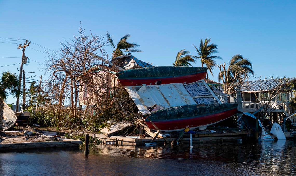 A catamaran sits on top of a home in a canal on Friday, Sept. 30, 2022, in St. James City, Fla., in Pine Island Hurricane Ian made landfall on the coast of Southwest Florida as a category 4 storm Tuesday afternoon leaving areas affected with flooded streets, downed trees and scattered debris. Pine Island residents can’t get to the island due to damaged bridges and roads.