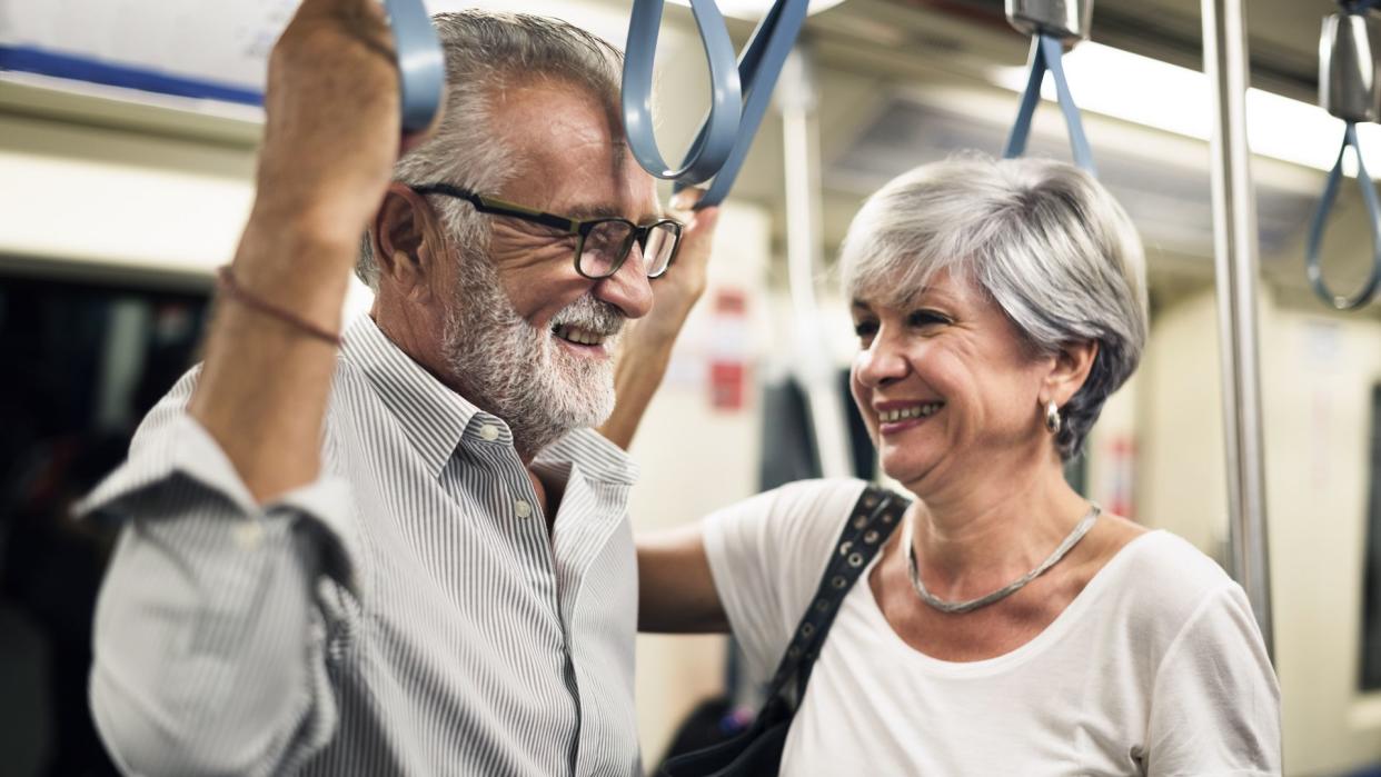 Senior couple traveling inside train subway.