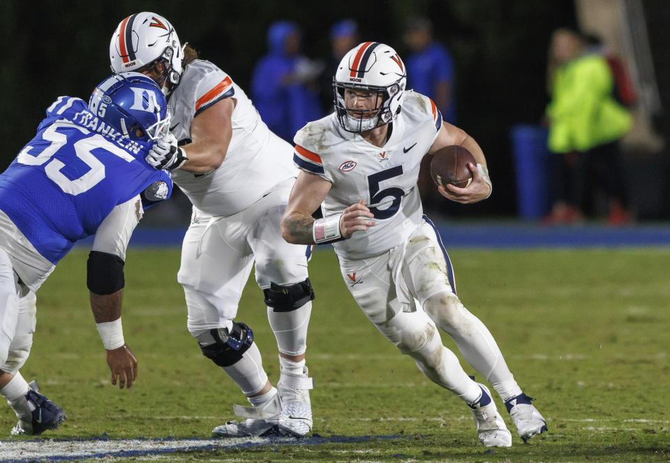 Virginia's Brennan Armstrong (5) carries the ball during the first half of the team's NCAA college football game against Duke in Durham, N.C., Saturday, Oct. 1, 2022. (AP Photo/Ben McKeown)