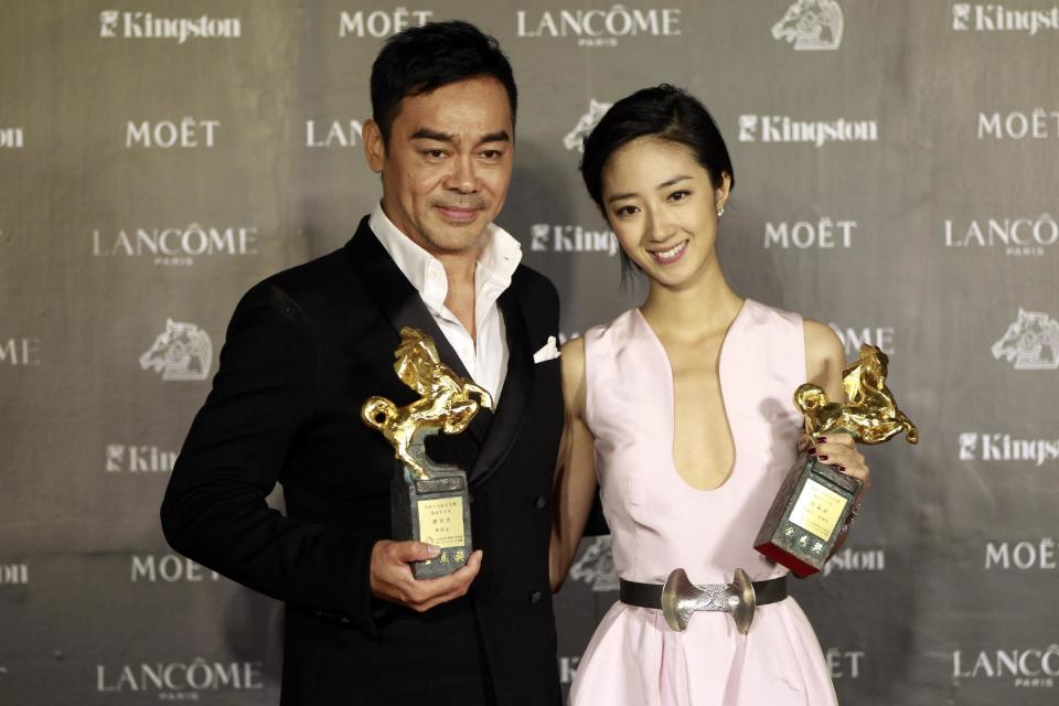 Taiwanese actress Gwei Lun-Mei and Hong Kong actor Lau ChingWan hold their awards for Best Actress and Best Actor for the film "GF * BF" and "Life Without Principle" at the 49th Golden Horse Awards at the Luodong Cultural Working House in Yilan County, Taiwan, Saturday, Nov. 24, 2012. The Golden Horse awards are the Chinese-language film industry's biggest annual events. (AP Photo/Wally Santana)