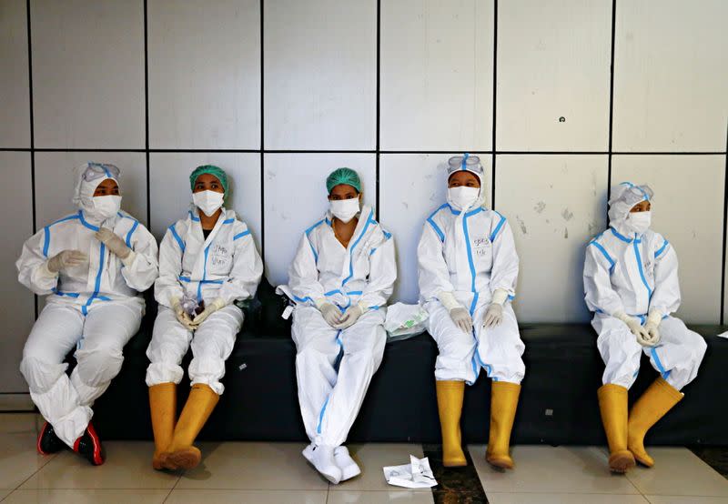 FILE PHOTO: Healthcare workers wearing PPE get ready to treat patients at the emergency hospital for COVID-19, in Jakarta