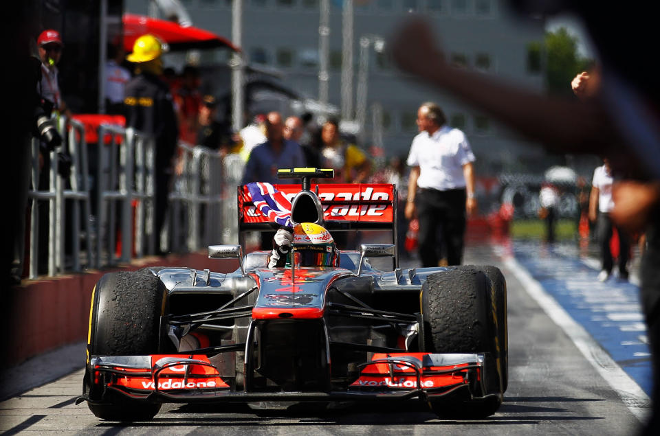 MONTREAL, CANADA - JUNE 10: Lewis Hamilton of Great Britain and McLaren waves the Union Jack flag in celebration as he drives down the pitlane after winning the Canadian Formula One Grand Prix at the Circuit Gilles Villeneuve on June 10, 2012 in Montreal, Canada. (Photo by Paul Gilham/Getty Images)