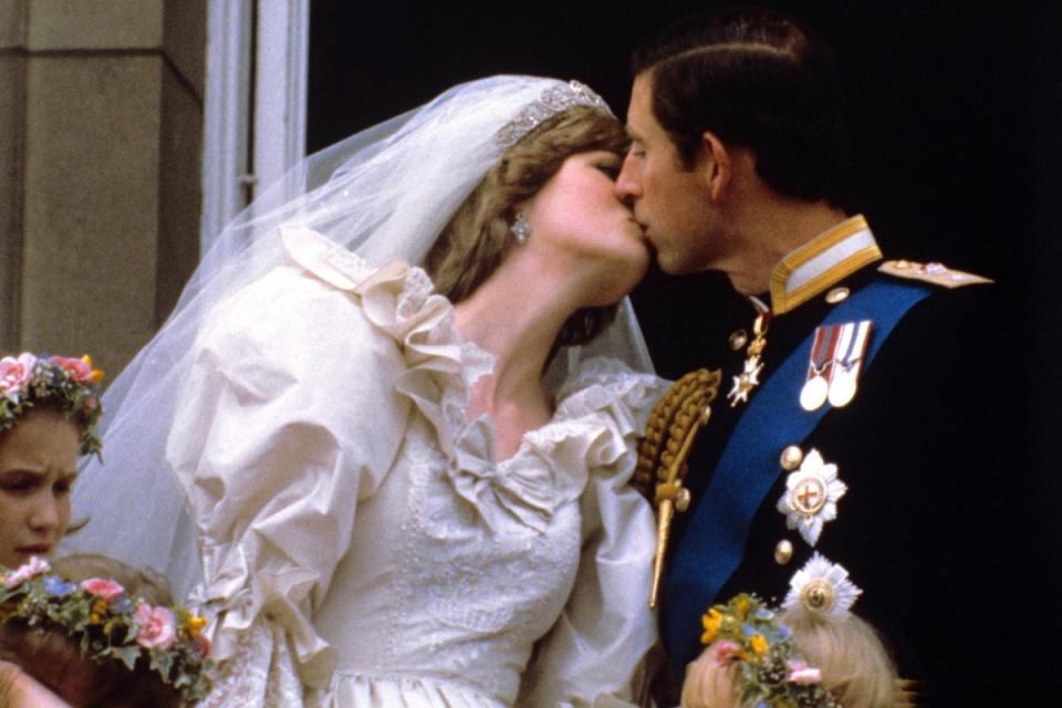 Diana, Princess of Wales kissing Prince Charles of Wales on the balcony of Buckingham Palace following their wedding in 1981 (PA)