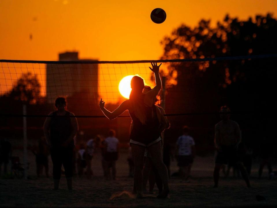 PHOTO: FILE - People play volleyball at sunset on Montrose Beach, Aug. 23, 2023, in Chicago. (Kiichiro Sato/AP, FILE)