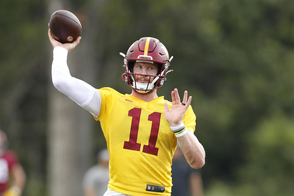 Washington Commanders quarterback Carson Wentz throws a pass during an NFL football practice at Inova Sports Performance Center in Ashburn, Va., Monday, Aug. 22, 2022. (AP Photo/Luis M. Alvarez)