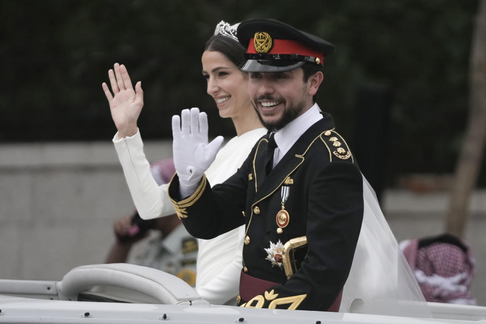 Jordan's Crown Prince Hussein and Saudi Rajwa Alseif wave to well-wishers during their wedding ceremonies in Amman, Jordan, Thursday, June 1, 2023. (AP Photo/Nasser Nasser)