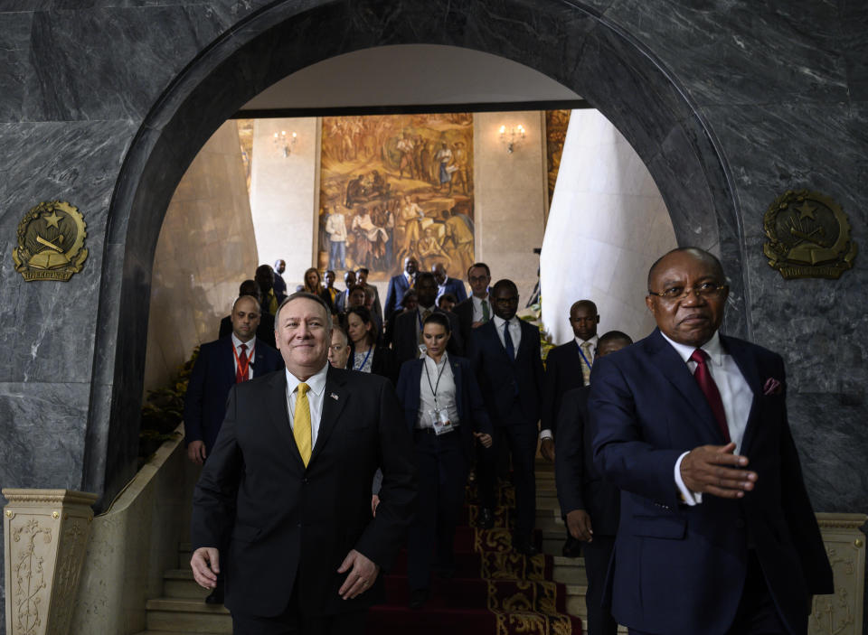 US Secretary of State Mike Pompeo, left, leaves with Angola Foreign Minister, Manuel Domingos Augusto after a press conference at the Ministry of Foreign Affairs in Luanda, Angola, Monday Feb. 17, 2020. Pompeo started his tour of Africa in Senegal, the first U.S. Cabinet official to visit in more than 18 months. He left Senegal Sunday to arrive in Angola and will then travel on to Ethiopia as the Trump administration tries to counter the growing interest of China, Russia and other global powers in Africa and its booming young population of more than 1.2 billion. (Andrew Caballero-Reynolds/Pool via AP)