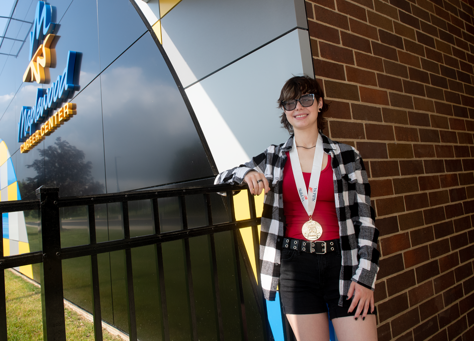 Sarah Penix, a recent Waterloo High School graduate, poses at Maplewood Career Center with her metal from the SkillsUSA Medical Assisting contest.