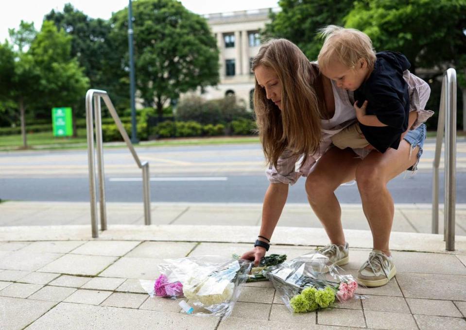 Flowers were placed outside the headquarters for the Charlotte-Mecklenburg Police Department on Tuesday to honor officers injured and killed serving warrant in east Charlotte home on Monday afternoon.