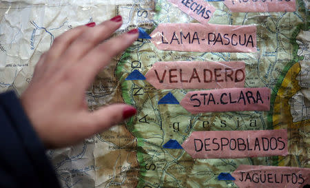 Enviromental activist Virginia Carpio shows mines' sites on a map inside a tent set up to protest against Barrick Gold Corp's Veladero gold mine in Jachal, San Juan province, Argentina, April 27, 2017. REUTERS/Marcos Brindicci