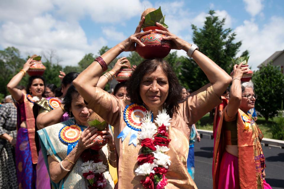 Community members walk around the building while singing, dancing, playing instruments and ringing a bell as a part of the Prana Pratishtha, grand opening, activities at Samarpan Hindu Temple & Community Center in Bensalem on Friday, June 24, 2022.