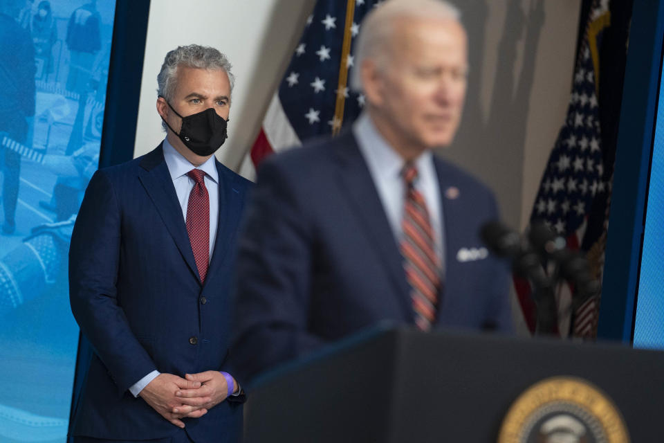 Jeff Zients, White House COVID-19 coordinator, left, wears a protective mask while listening as President Joe Biden on April 21, 2021.  / Credit: Sarah Silbiger/Bloomberg via Getty Images