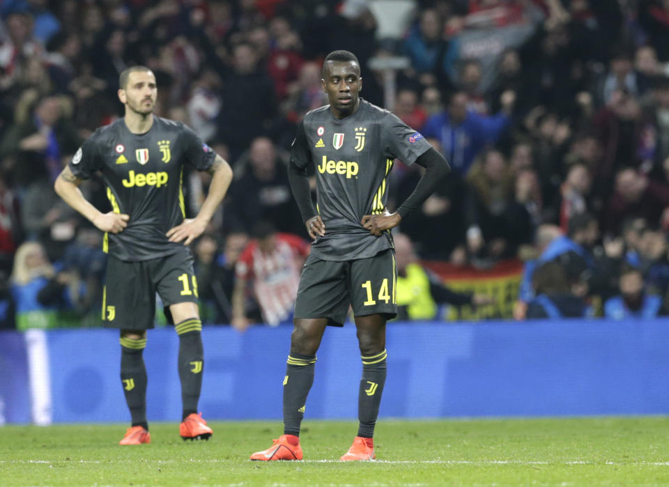 Juventus midfielder Blaise Matuidi and Juventus defender Leonardo Bonucci look as Atletico defender Diego Godin celebrates scoring his side's 2nd goal, during the Champions League round of 16 first leg soccer match between Atletico Madrid and Juventus at Wanda Metropolitano stadium in Madrid, Wednesday, Feb. 20, 2019. (AP Photo/Andrea Comas)