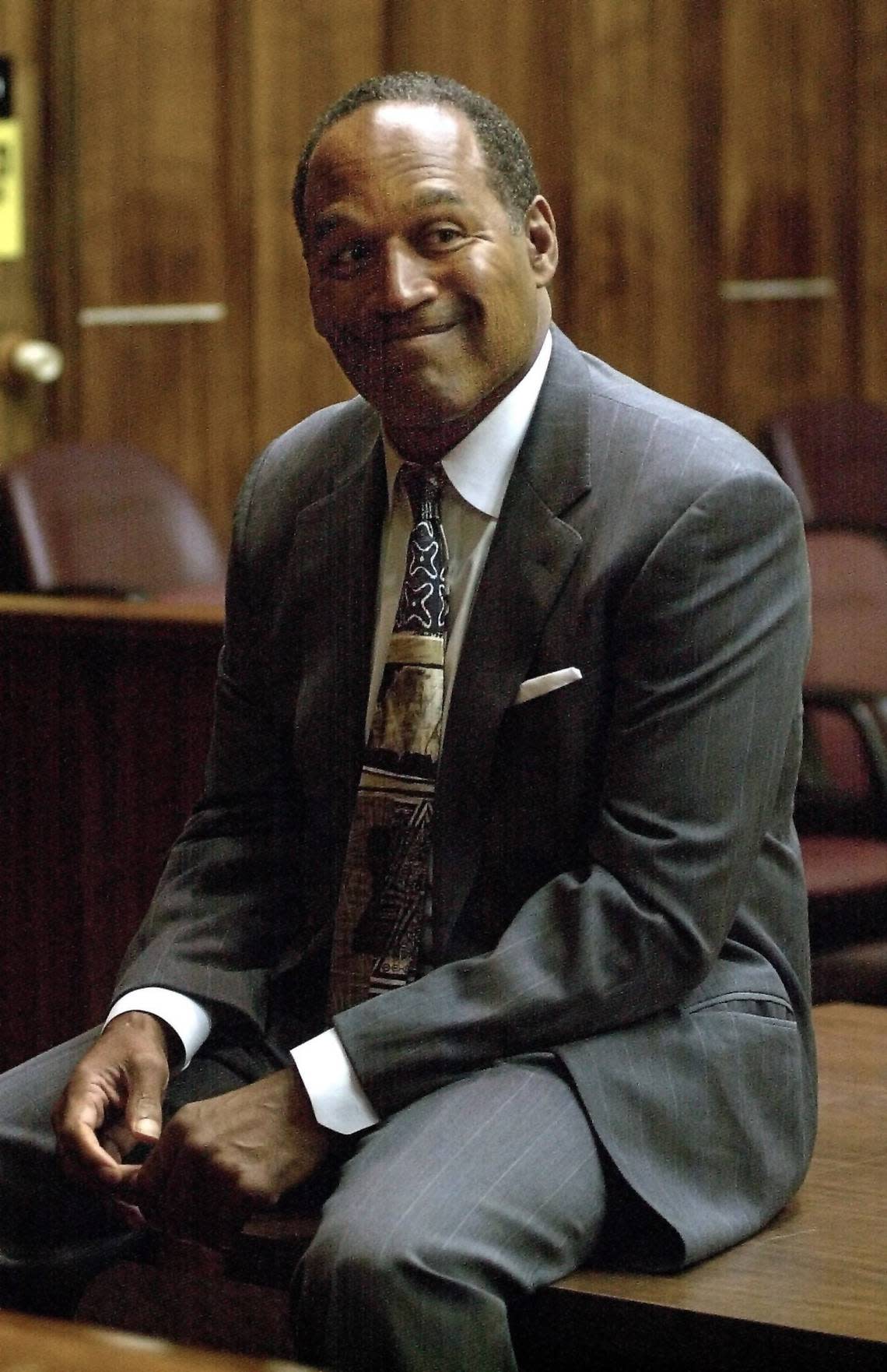 Former NFL star O.J. Simpson sits and waits for the beginning of court on Day Two of his road rage trial in Miami on Oct. 22, 2001. Simpson, who was acquitted in 1995 of murdering his ex-wife and her friend, was on trial on charges of felony auto burglary and misdemeanor battery. POOL PHOTO