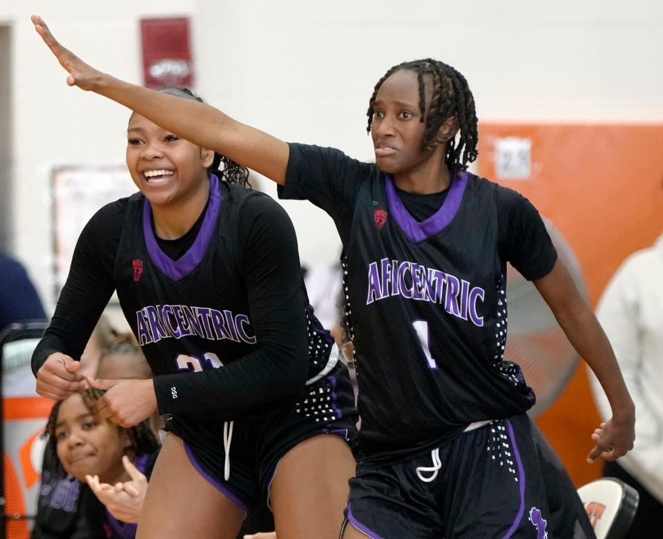 Africentric's Natiah Nelson, left, and Ashtan Winfrey cheer from the bench during the City League championship game against Centennial on Feb. 10 at East.