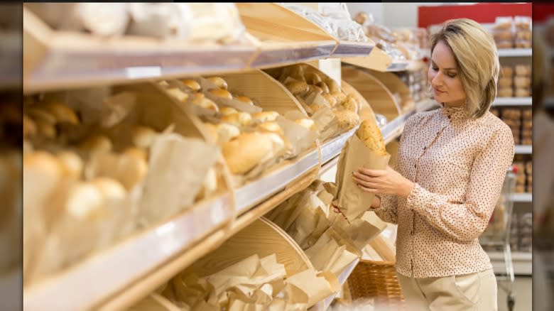 Woman selecting bread in market