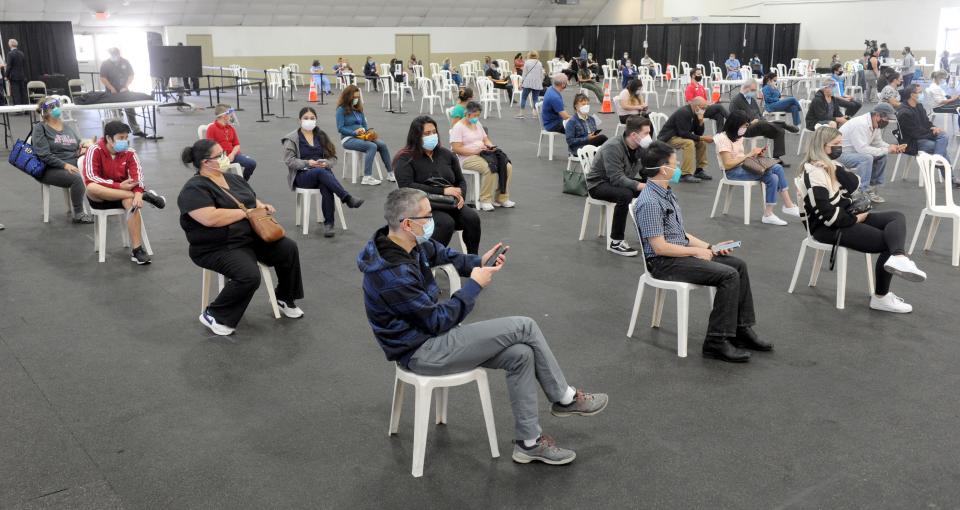 Health care workers wait to get the COVID-19 vaccination at the Ventura County Fairgrounds on Jan. 13, 2021.