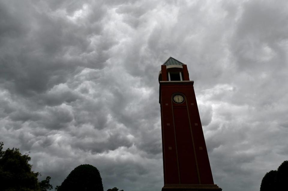 Storm clouds pass over the clock tower in the Village of Lake Park in Union County on Monday, August 7, 2023.