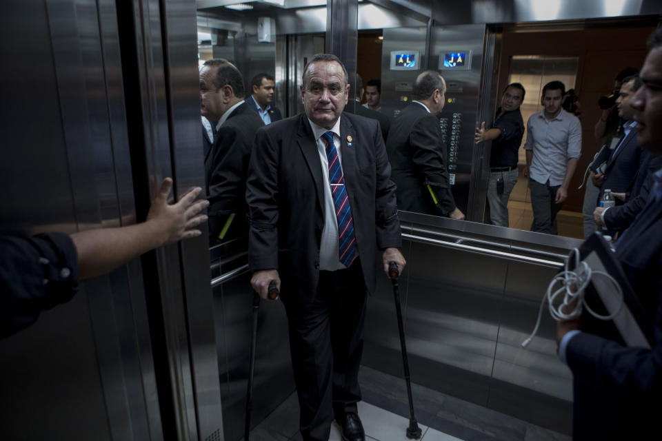 Guatemala's President-elect Alejandro Giammattei stands in an elevator as he arrives for an interview in Guatemala City, Tuesday, Aug. 13, 2019. Giammattei said Tuesday that Guatemala will not be able to hold up its side of an immigration agreement with the United States by serving as a “safe third country” for asylum seekers. (AP Photo/Oliver de Ros)