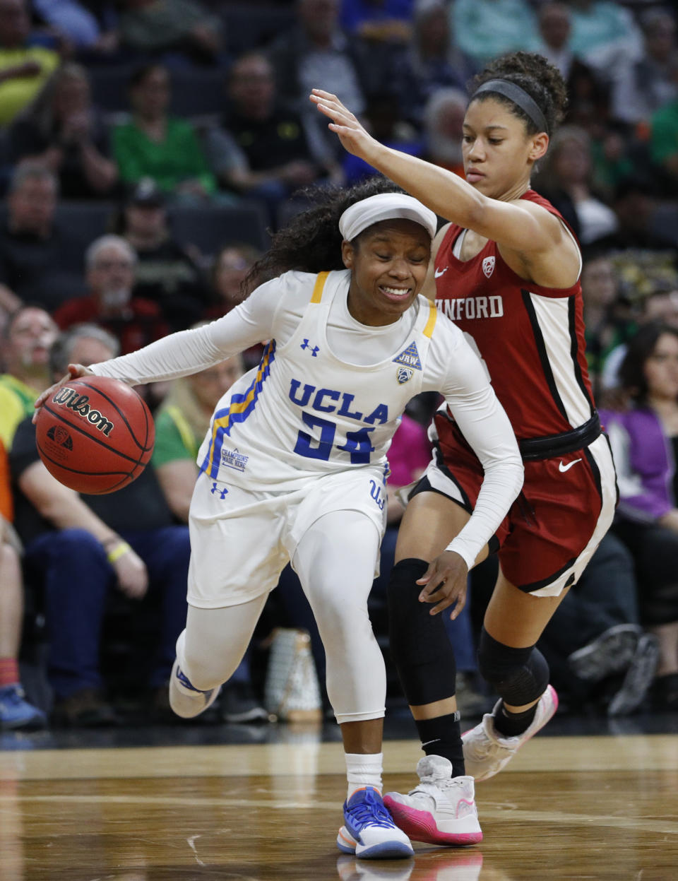 UCLA's Japreece Dean (24) drives around Stanford's Anna Wilson (3) during the second half of an NCAA college basketball game in the semifinal round of the Pac-12 women's tournament Saturday, March 7, 2020, in Las Vegas. (AP Photo/John Locher)