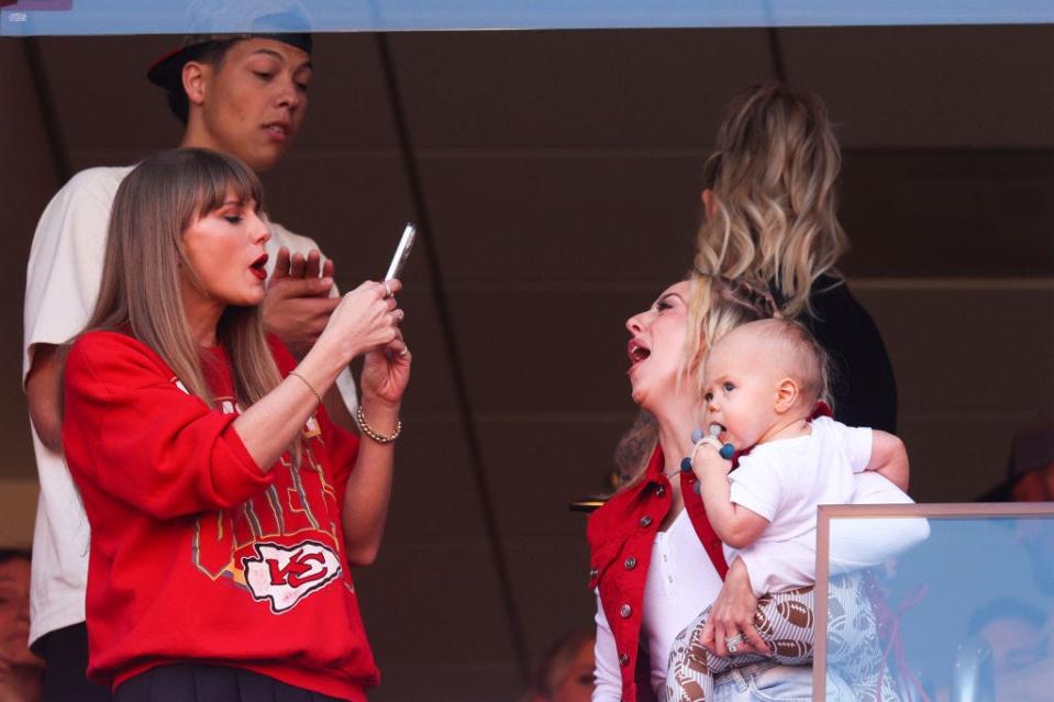 Taylor Swift takes a photo of Brittany Mahomes during a football game