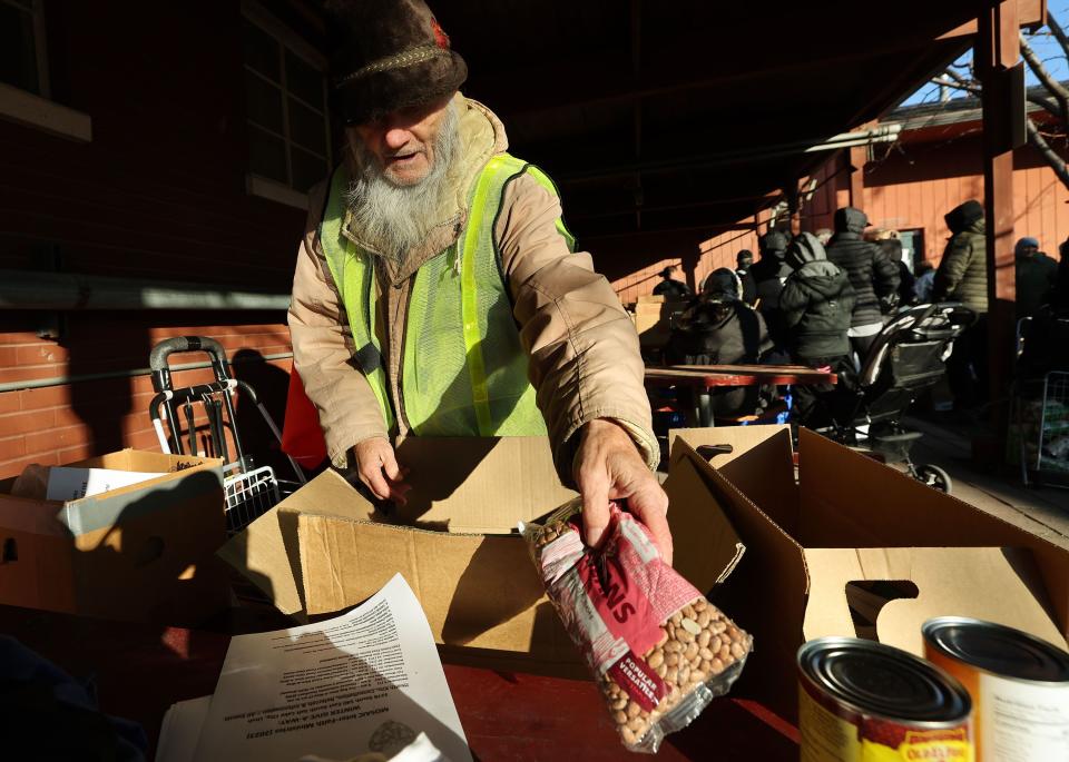 Hal (no last name to be used) receives food as Mosaic Inter-Faith Ministries hands out Thanksgiving meals in Salt Lake City on Tuesday, Nov. 21, 2023. | Jeffrey D. Allred, Deseret News