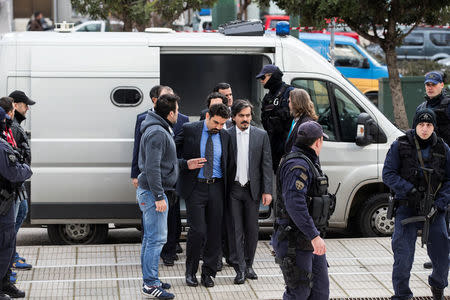 The eight Turkish soldiers, who fled to Greece in a helicopter and requested political asylum after a failed military coup against the government, are escorted by police officers as they arrive at the Supreme Court in Athens, Greece, January 26, 2017. REUTERS/Alkis Konstantinidis