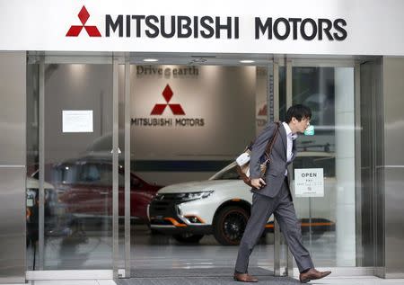 A man walks out from Mitsubishi Motors Corp's showroom at its headquarters in Tokyo, Japan, April 21, 2016. REUTERS/Toru Hanai