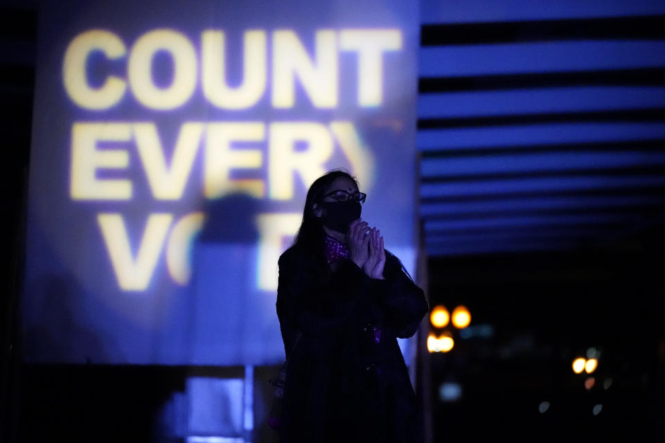 A woman listens during a protest after the Nov. 3 elections, Wednesday, Nov. 4, 2020, in Portland, Ore. (AP Photo/Marcio Jose Sanchez)