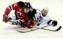 NEWARK, NJ - JUNE 09: Alexei Ponikarovsky #12 of the New Jersey Devils collides with Drew Doughty #8 of the Los Angeles Kings during Game Five of the 2012 NHL Stanley Cup Final at the Prudential Center on June 9, 2012 in Newark, New Jersey. (Photo by Elsa/Getty Images)