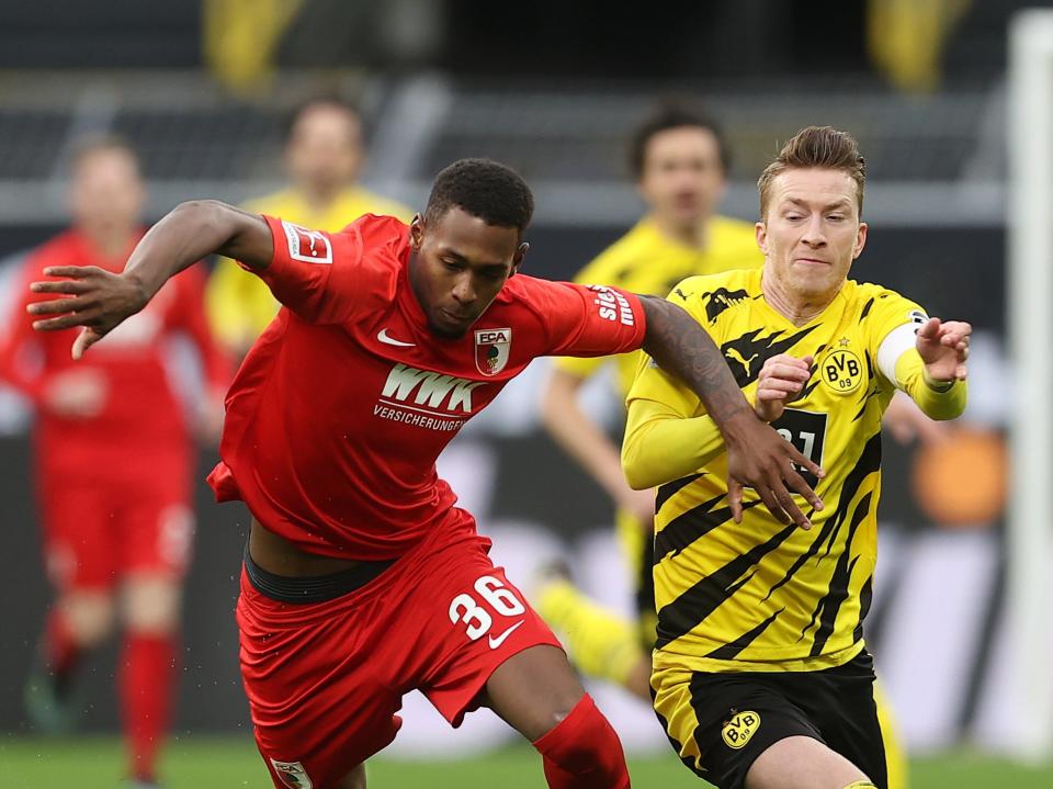 Reece Oxford vies for the ball against Borussia Dortmund’s Marco Reus (Getty Images)