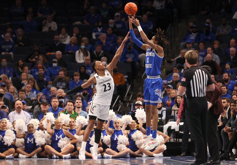 Memphis Tigers guard Emoni Bates shoots the ball over Cincinnati Bearcats guard Mika Adams-Woods at FedExForum on Sunday, Jan. 9, 2022. 