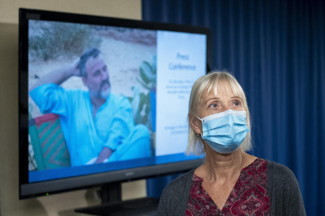 FILE - Els Woodke speaks about the 2016 kidnapping of her husband Jeffrey Woodke, photo on video monitor, in West Africa, during a news conference in Washington, Nov. 17, 2021. The Biden administration says the American aid worker who was kidnapped in Niger six years ago has been released from custody. Jeffrey Woodke was kidnapped from his home in Abalak, Niger, in October 2016 by men who ambushed and killed his guards and forced him at gunpoint into their truck, where he was driven north toward Mali’s border. (AP Photo/Cliff Owen, File)
