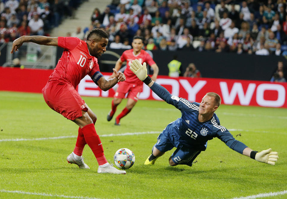 Peru's Jefferson Frafan, left, misses too score against German goal keeper Marc Andree per Steven during a friendly soccer match between Germany and Peru in Sinsheim, Germany, Sunday, Sept. 9, 2018. (AP Photo/Michael Probst)