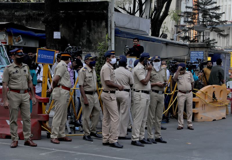 People stand outside the Breach Candy Hospital after the death of singer Lata Mangeshkar in Mumbai