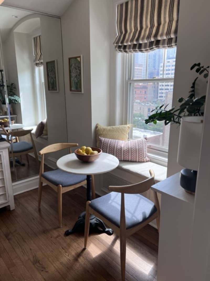 small dining nook by a window with window bench