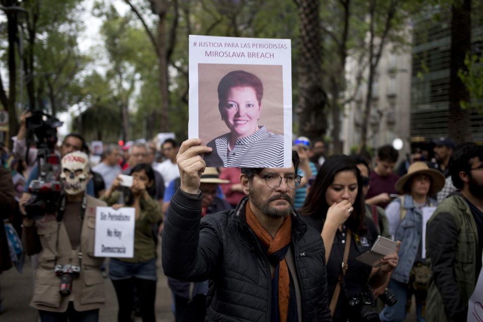 A man holds up a photo of Mexican journalist Miroslava Breach, gunned down in the northern state of Chihuahua on Thursday, during a march in Mexico City, Saturday, March 25, 2017. Breach was the third journalist to be killed this month in one of the most dangerous countries for media workers. (AP Photo/Eduardo Verdugo)