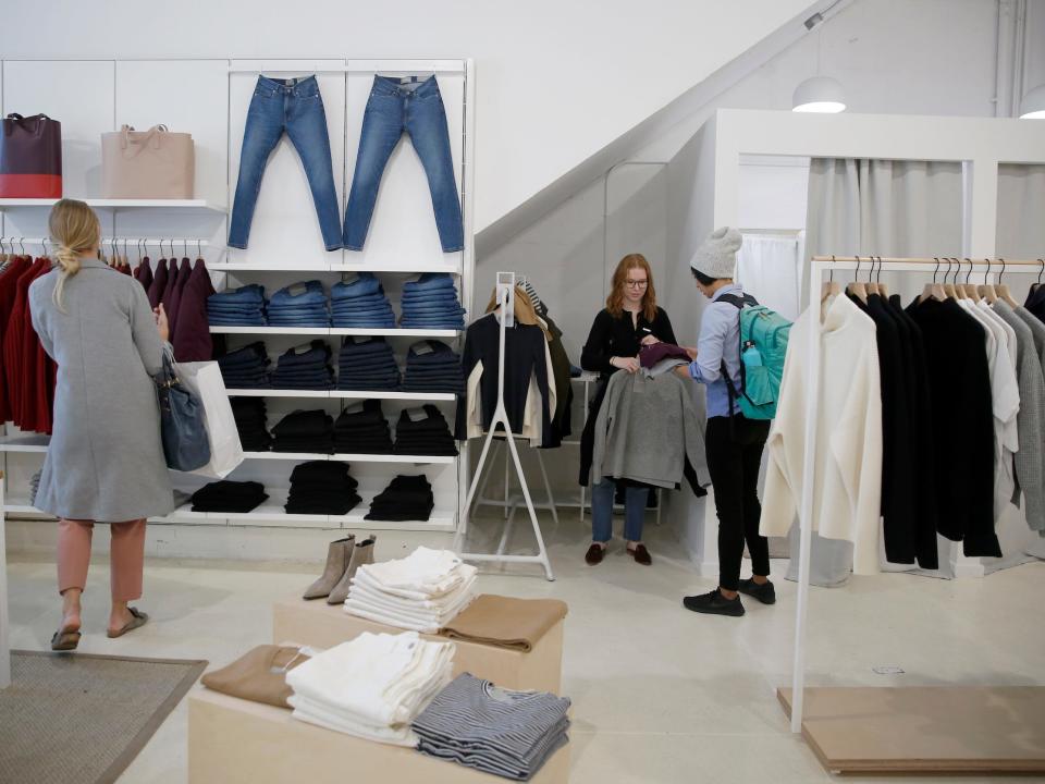 Customers shop at Everlane store with clothing on display