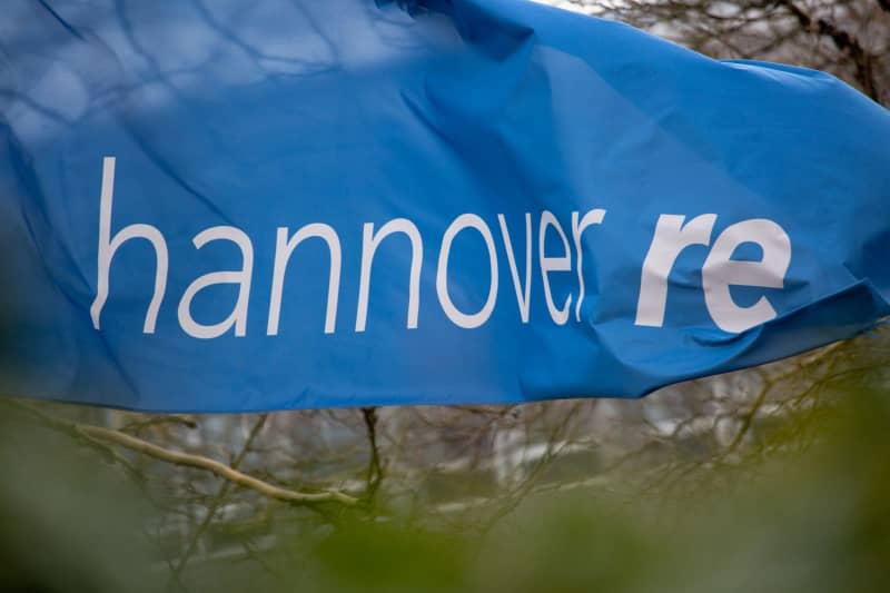 A Hannover Re flag is flying in front of the insurance company's headquarters. Raphael Knipping/dpa