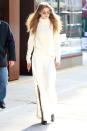 <p>In a Stephanie Rad oversized ivory cashmere turtleneck, slitted high waisted wide leg trousers and knee high snakeskin pointed boots while out in New York. </p>