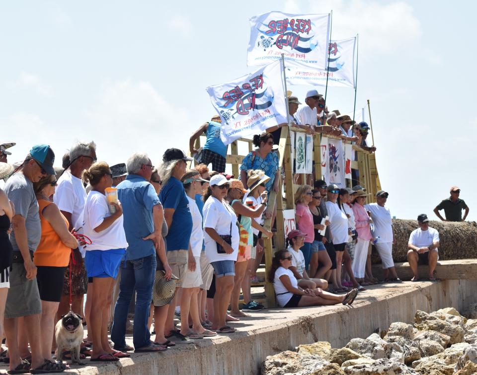 Port Aransas residents and opponents of the Port of Corpus Christi's plans for Harbor Island listen to speakers during a protest on July 20, 2019.